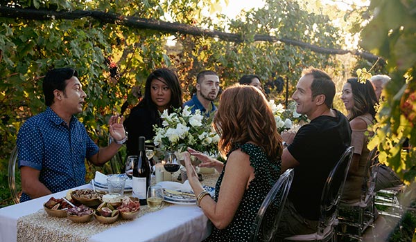 Couples having dinner in vineyard